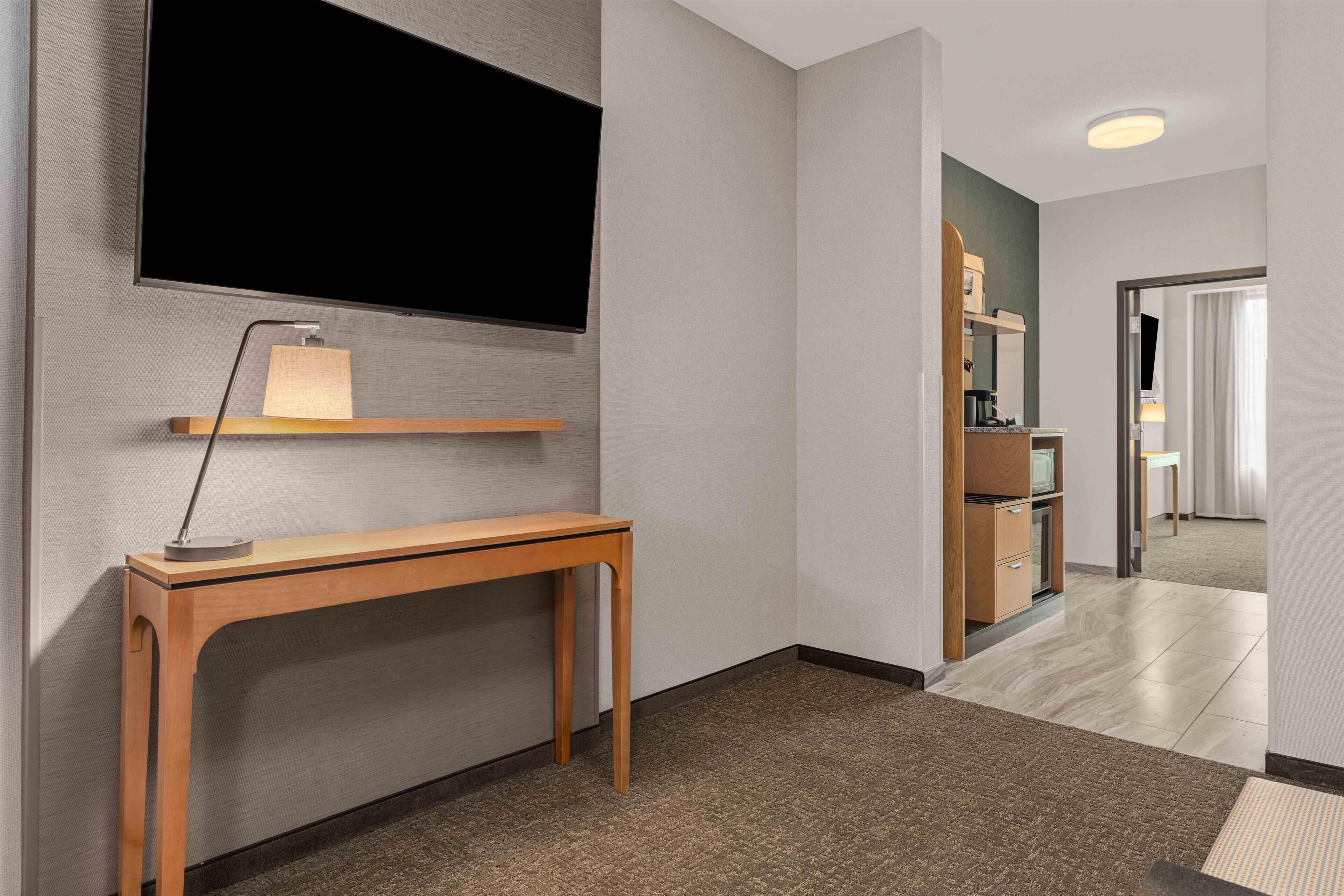 Premium bedding, desk, laptop workspace, blackout drapes
