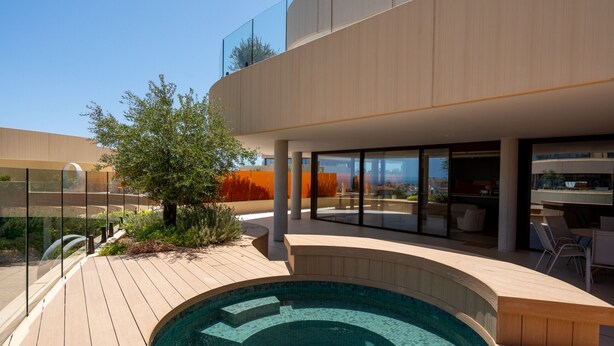 Ein modernes Gebäude mit Pool, Außenbereich und großen Fenstern.