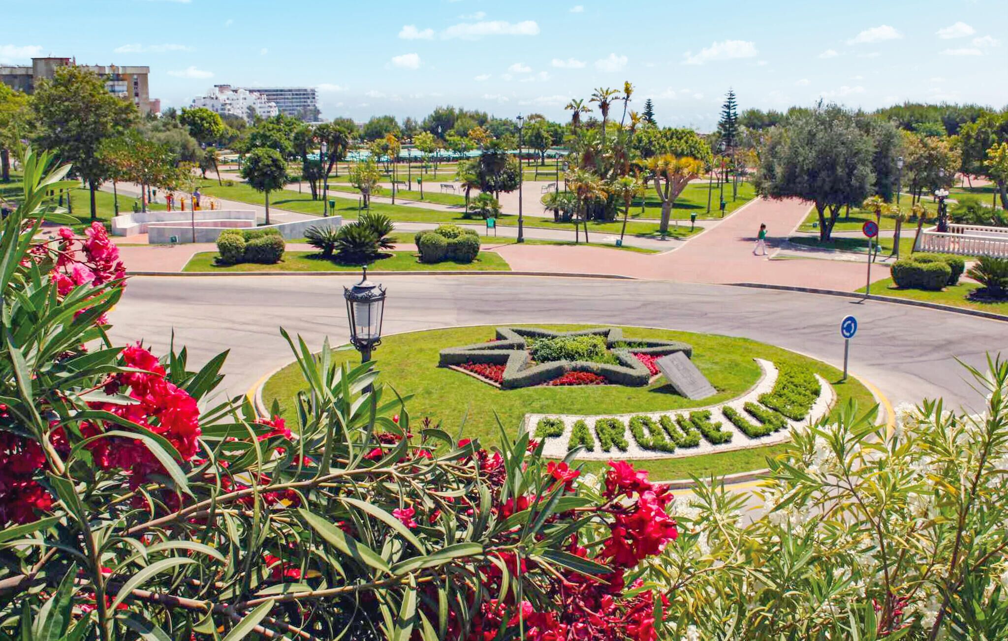 A landscaped area with a central star-shaped garden, pathways, and surrounding greenery.