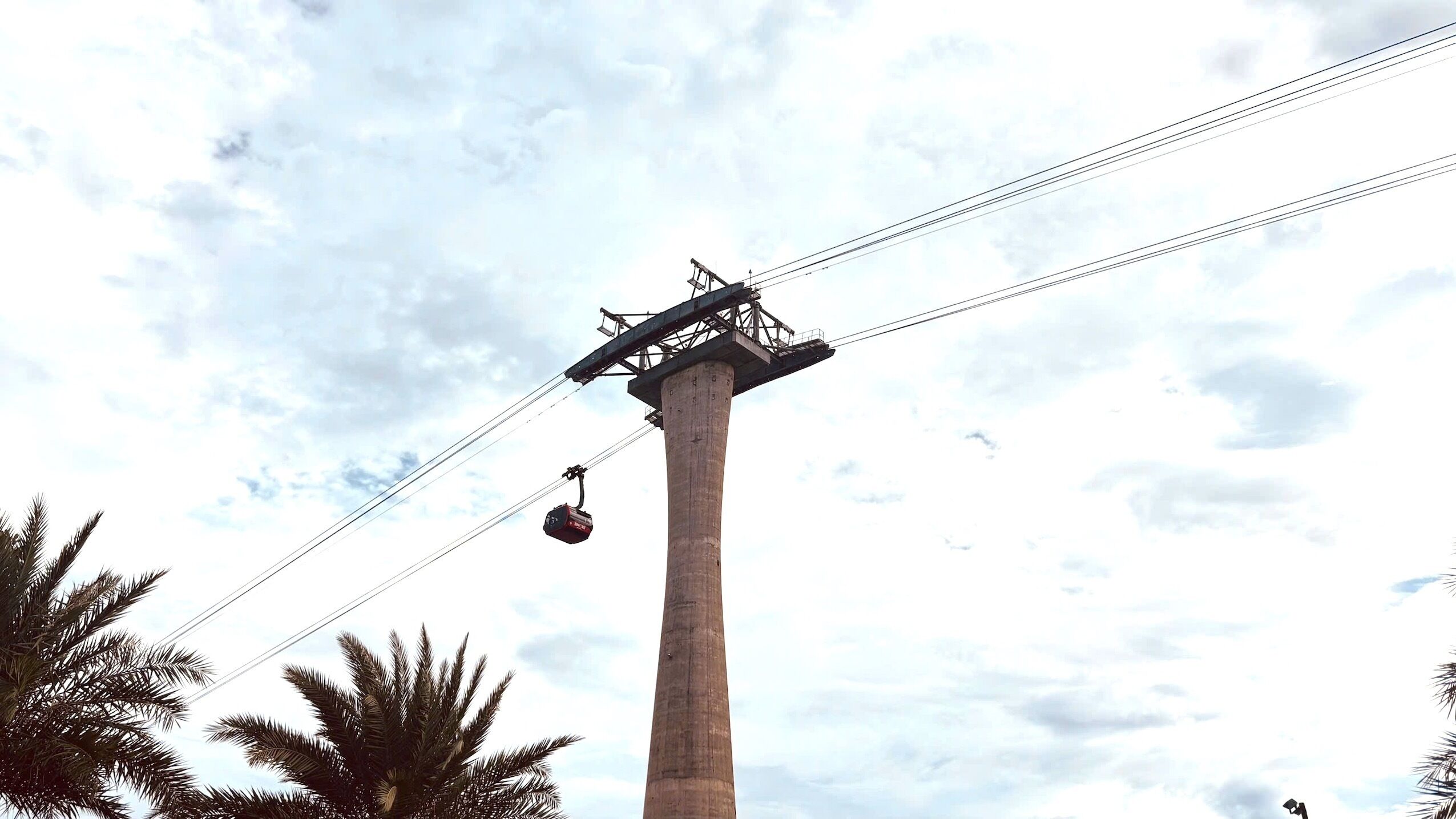 A tall concrete structure with a cable car system.