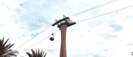 A tall concrete structure with a cable car system.