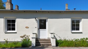 A two-story building with a white exterior, a front door, and two windows on the ground floor. - Surfer's Paradise Wiek - Lee Vacation Rental (Wiek)