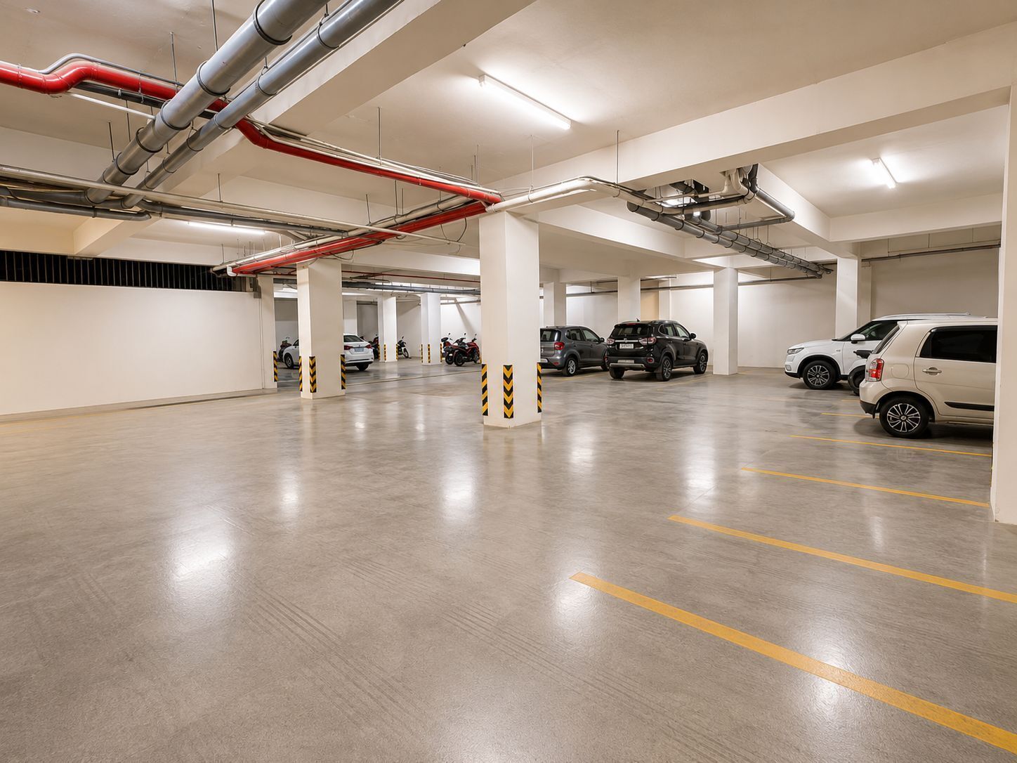 A multi-level parking garage with concrete floors and white walls.
