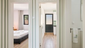 Ein Hotelzimmer mit einem Bett, einem Nachttisch und einem Vorhangfenster.