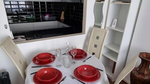 A dining table set with red plates, glasses, and cutlery, surrounded by chairs. - Ground Floor Flat, Free Parking, Near Tube Station (Edgware)