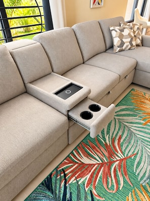 A beige sectional sofa with a built-in tray table and cup holders. - Peaceful Hilltop Retreat/Ocho Rios/Community Pool (Ocho Rios)