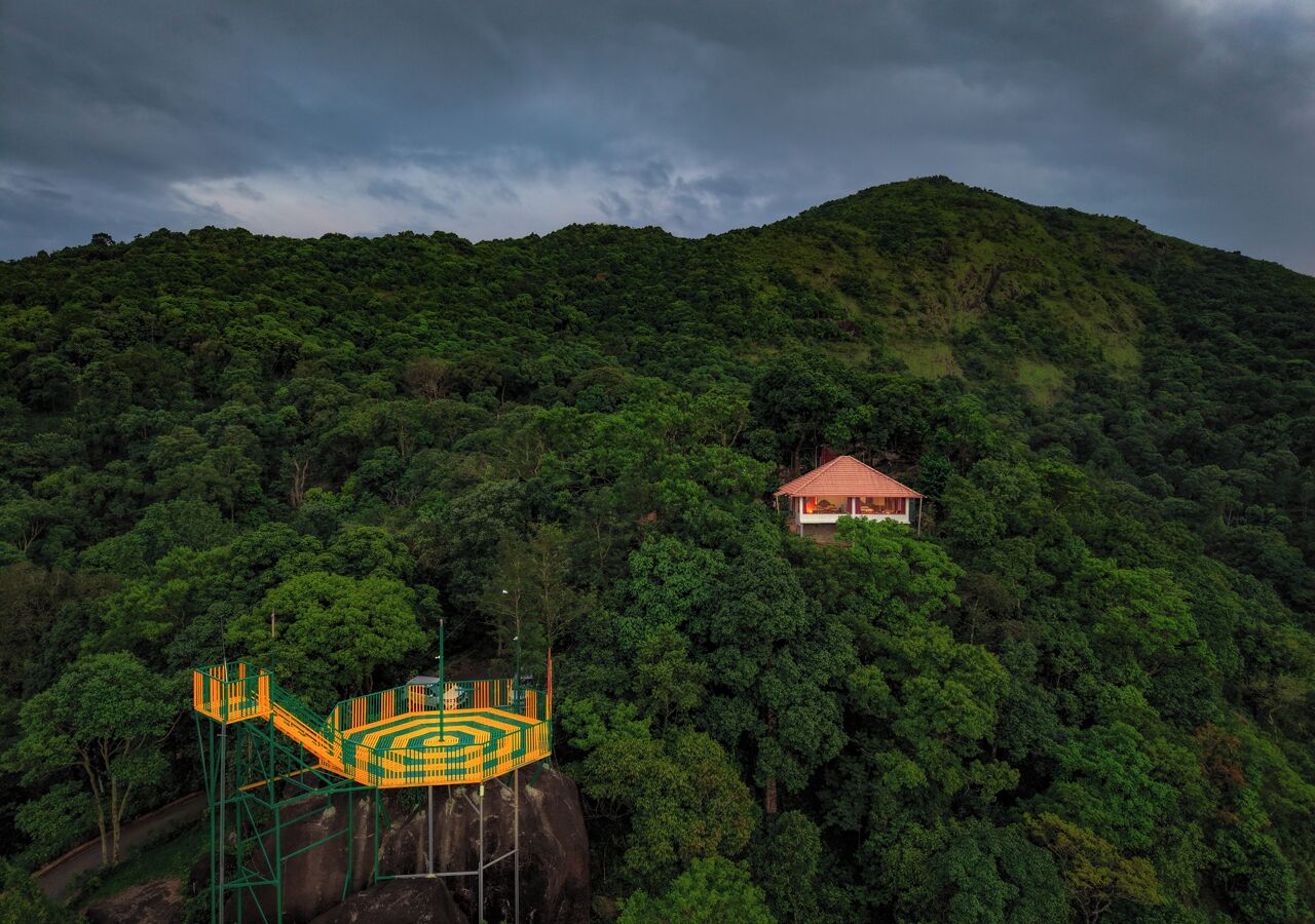 A house on a hillside with a playground structure.
