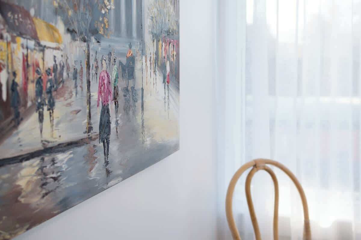 A painting of a street scene with people and buildings.