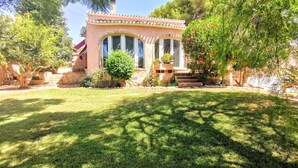 A house with a well-maintained lawn, a small garden, and a patio area. - VILLA JAVEA - TOSCAL (Javea)