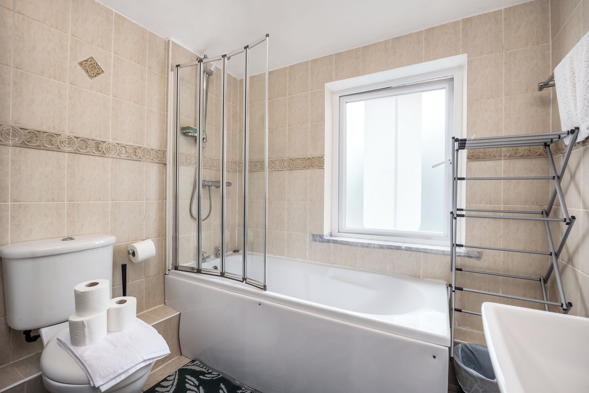 Shower, hair dryer, towels, toilet paper