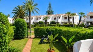 A courtyard with a paved walkway, potted plants, and a chair. - Ad3223 in Denia With 3 Bedrooms and 1 Bathrooms (Denia)