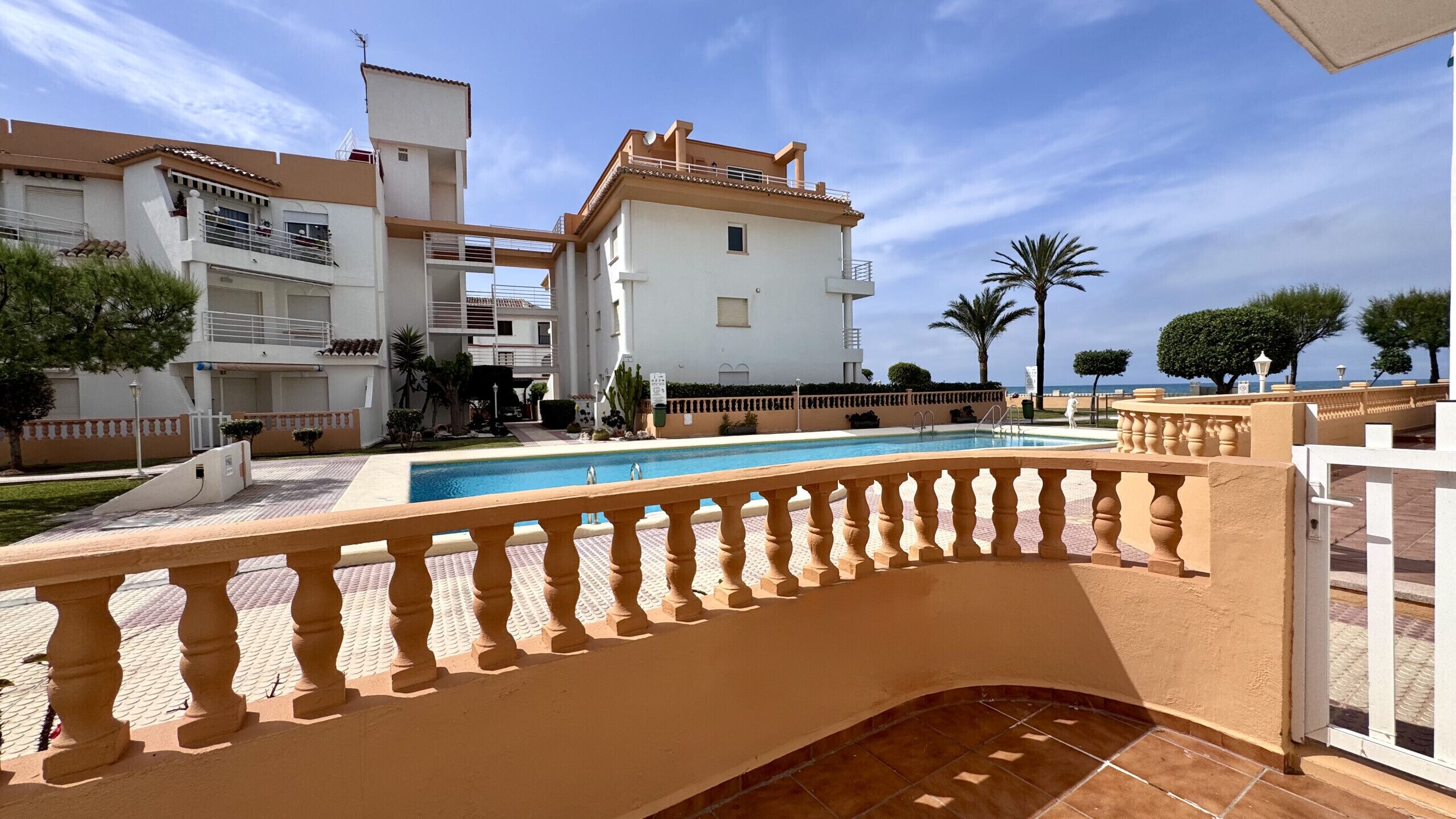 Zona de piscina con vista despejada de los edificios circundantes y una reja.