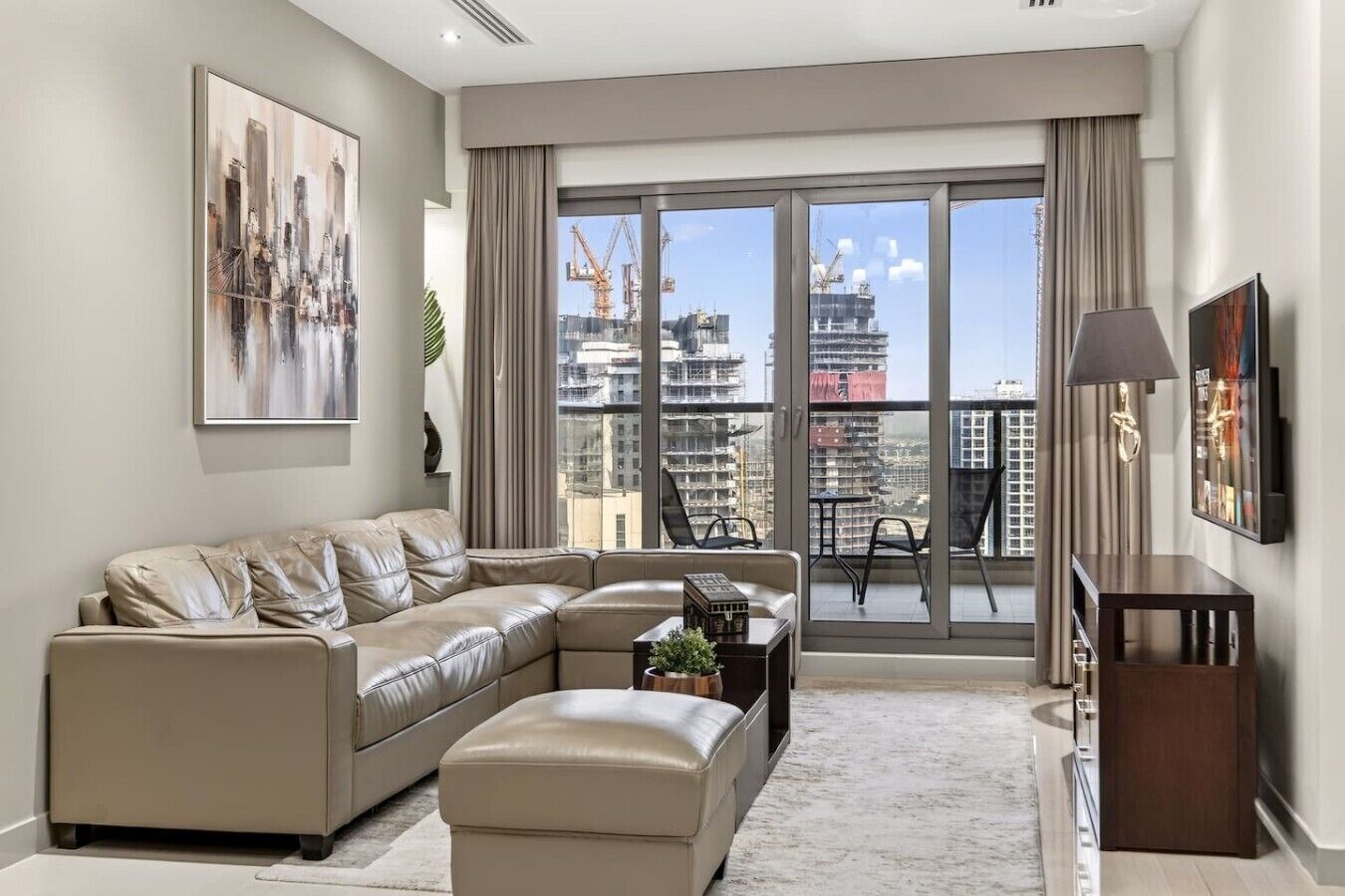 A modern living room with a sectional sofa, a coffee table, and a TV.