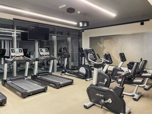 A gym with treadmills, elliptical machines, and weight stations. - FIRST CLASS |1BR| Sea Views | Direct Beach Access (Dubai Harbour)