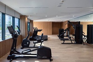 A gym with treadmills, elliptical machines, and weight equipment. - FIRST CLASS | 2BR | Luxury Escape in Meydan (Meydan)