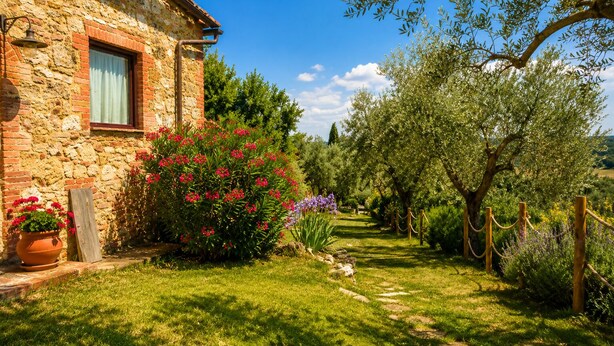 A stone building with a window, a garden with various plants, and a clear blue sky. - Stunning "La Quercia" Apartment in a Country House with a Pool and Panoramic View (Toscana)