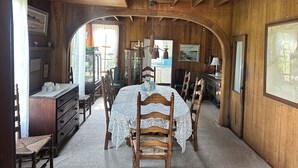 A wooden room with a bed, chairs, a dresser, and a desk. - Location, Location, Location! (Westerly)