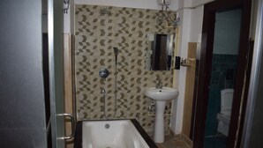 A bathroom with a bathtub, a sink, and a shower.