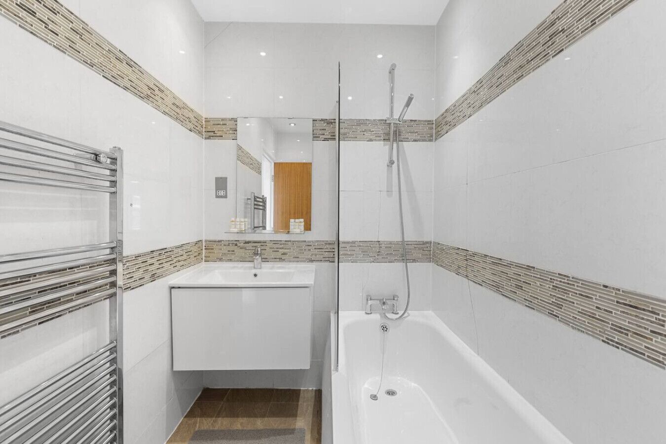 A modern bathroom with a bathtub, a sink, and a shower.