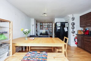 A compact kitchen with a dining table, a TV, and a refrigerator. - Spacious Double Ensuite 2 Min To Tube (Greater London)