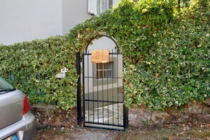 A gated entrance with a sign reading 'Salici' and a metal gate.