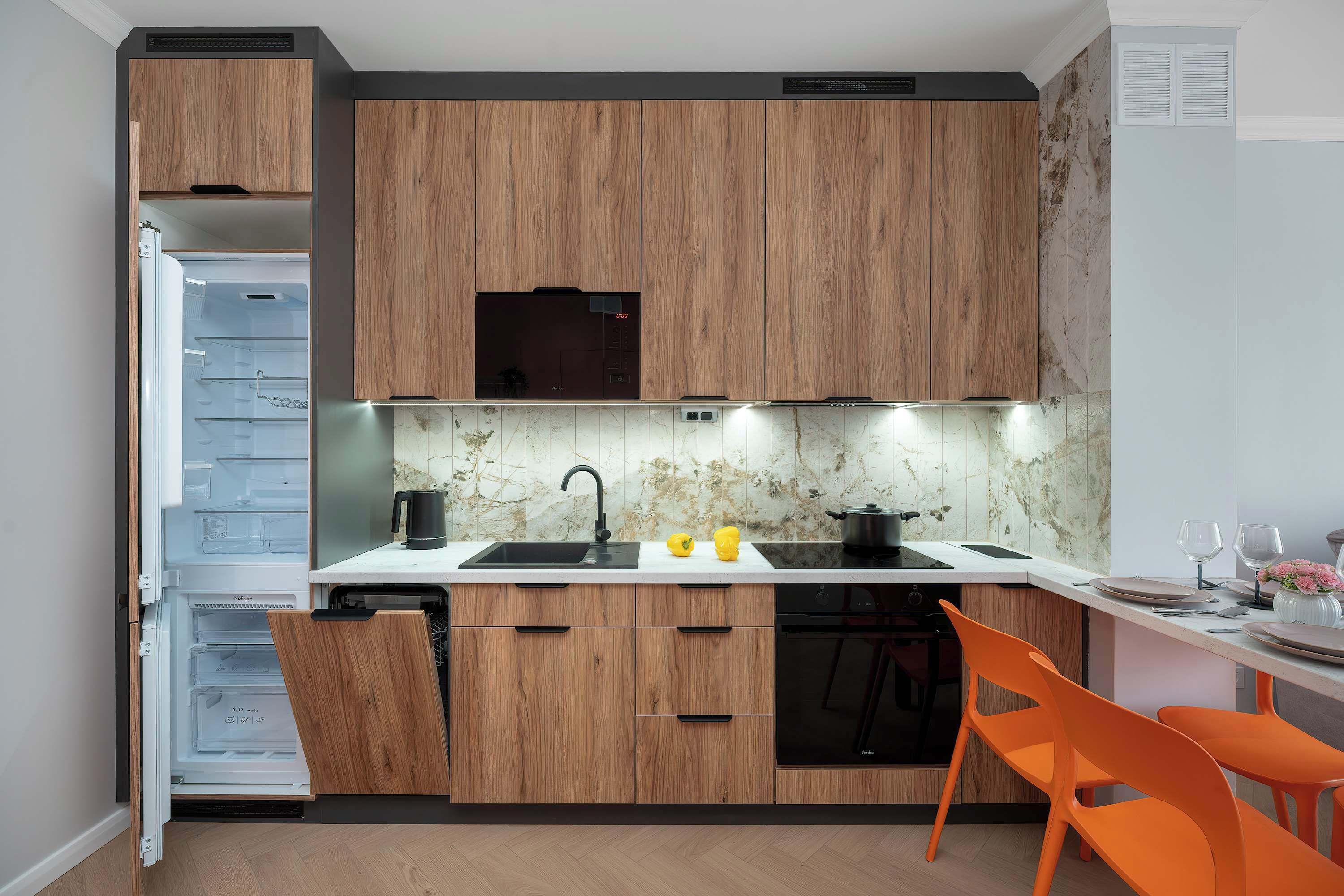 A modern kitchen with wooden cabinets, a built-in dishwasher, and a countertop with a sink.