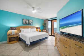 A bedroom with a bed, a television, and a view of the beach. - Four Seasons 901W by Liquid Life (Orange Beach)