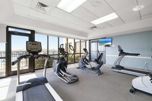 A gym with treadmills, elliptical machines, and a stationary bike. - Phoenix V 1509 by Liquid Life (Orange Beach)