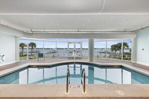 A swimming pool with clear glass walls, a lifebuoy, and a no diving sign. - Bel Sole 603 by Liquid Life (Gulf Shores)