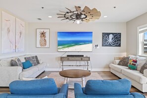 A living room with two sofas, a coffee table, and artwork on the walls. - Bella Vista by Liquid Life (Gulf Shores)