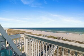 A beach view from a wooden deck with a clear sky. - Bella Vista by Liquid Life (Gulf Shores)