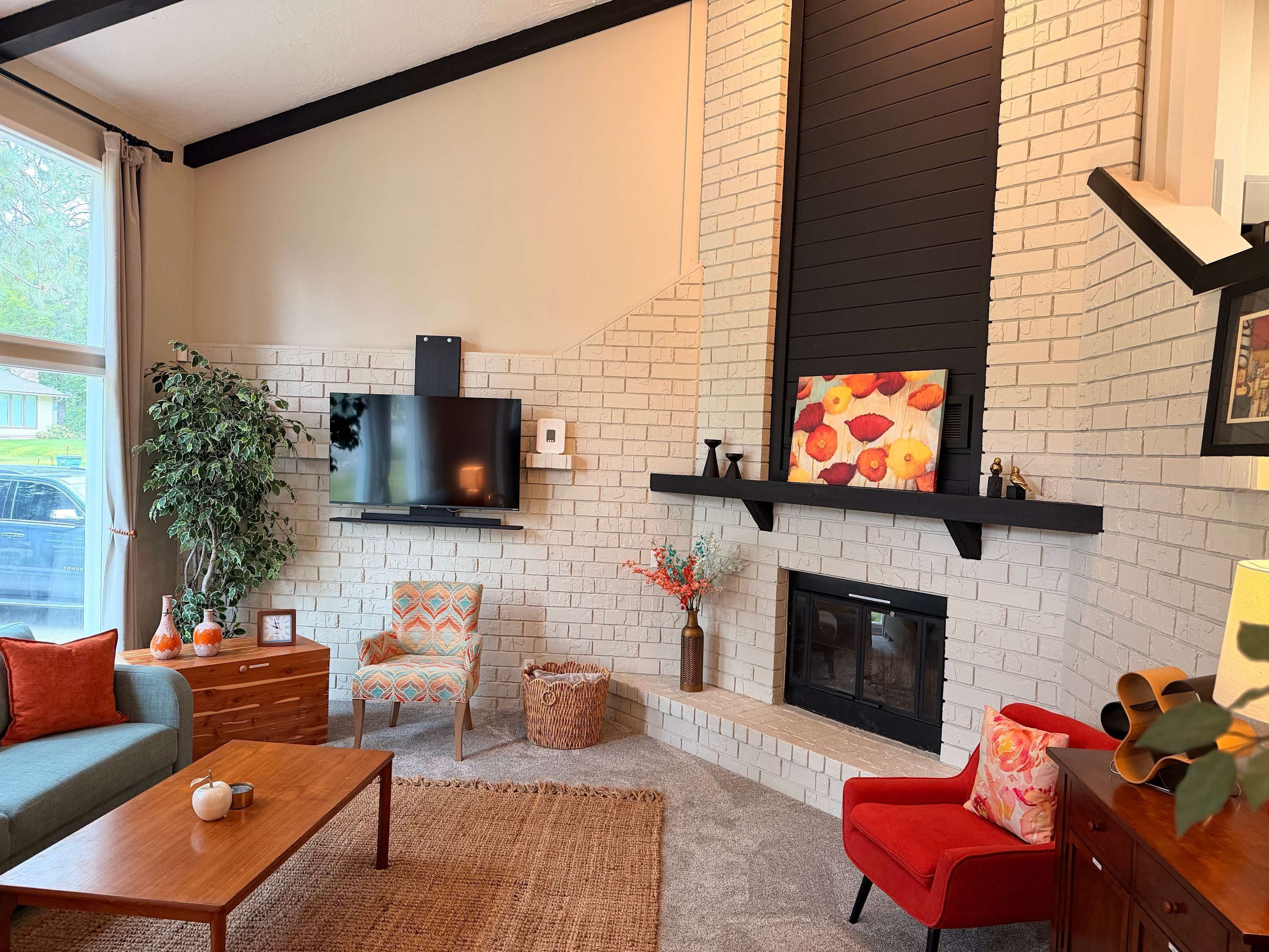 A living room with a fireplace, a television, and a sofa.