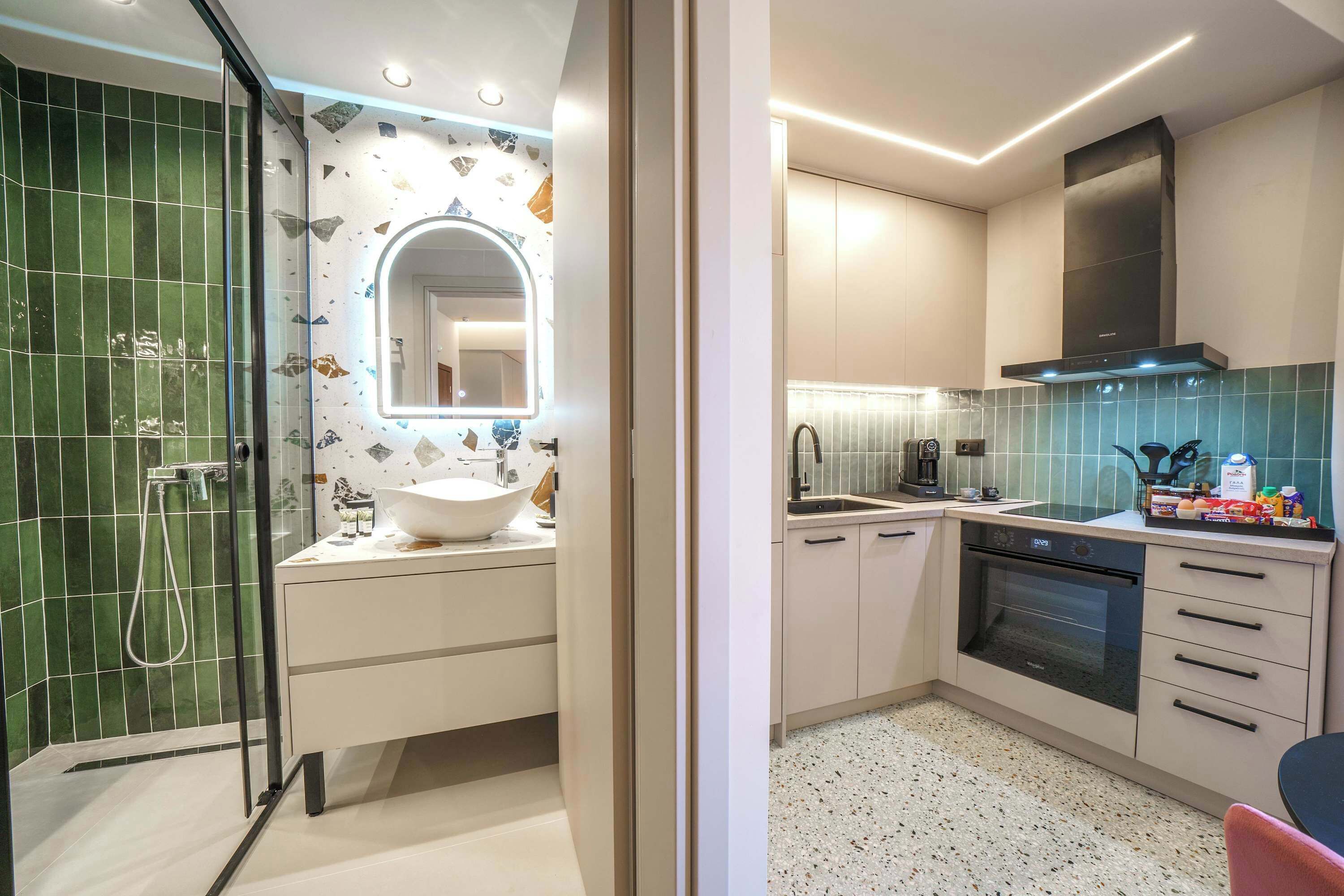 A modern kitchen with a built-in oven, a coffee maker, and a sink.