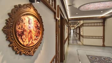 A corridor with ornate wall decorations and a patterned carpet.