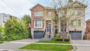 A two-story house with a brick facade, a front garage, and a well-maintained lawn. - Charming, Family Friendly 3 bedroom House with Home Theatre near airport/transit (Toronto)