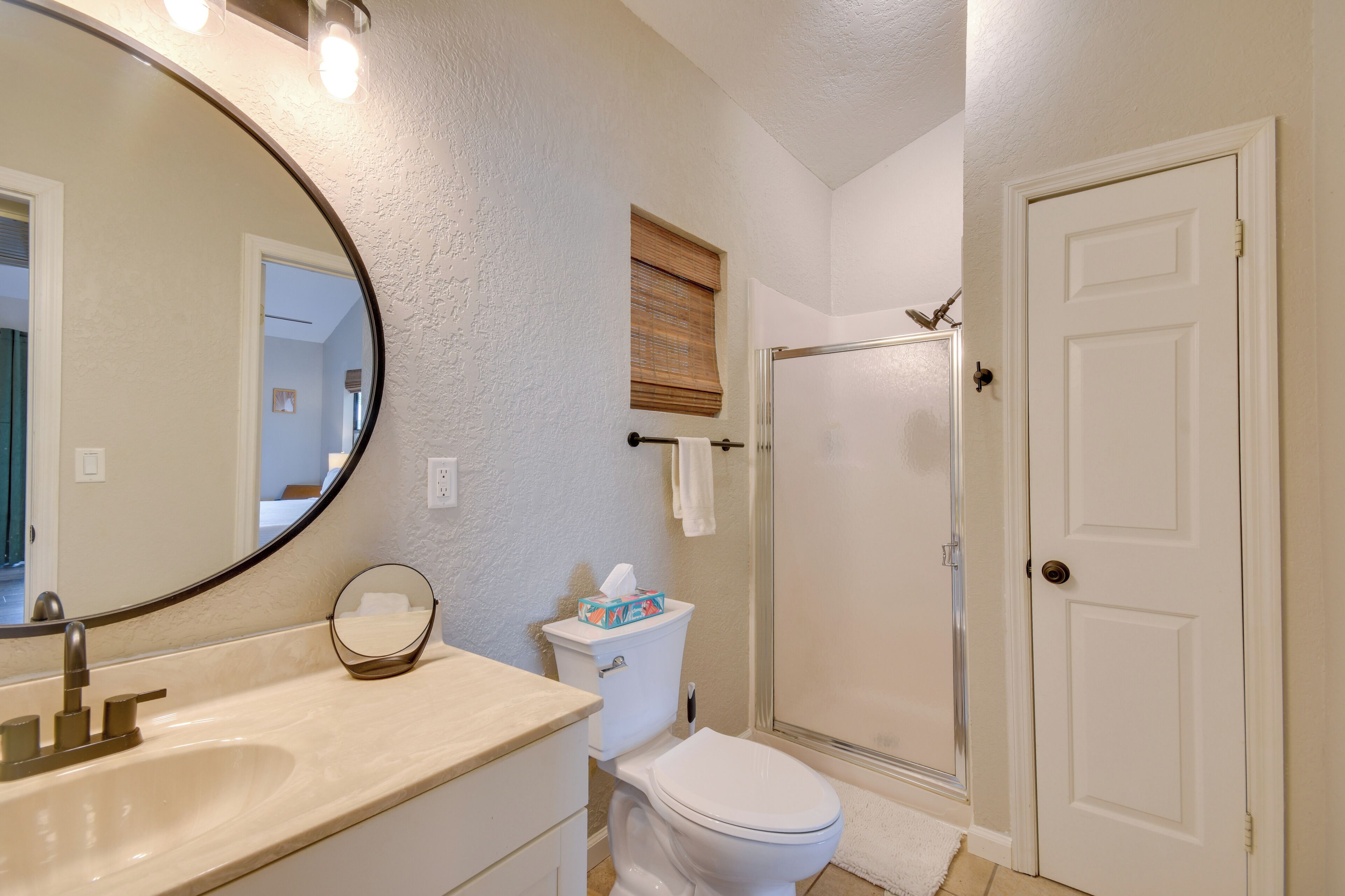 A bathroom with a sink, toilet, and shower.