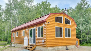 A wooden cabin with a red roof, large windows, and a chimney. - Secluded Cabin w/ UTV Trail Access in Harshaw! (Harshaw)