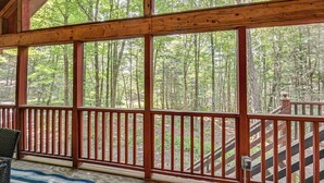 A wooden deck with a railing, large windows, and a view of a forest. - Screened Porch w/ Lake View! Tolland Family Haven (Granville)