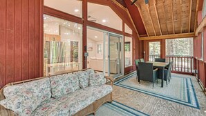 A covered porch with a wicker sofa, a dining table with chairs, and a ceiling fan. - Screened Porch w/ Lake View! Tolland Family Haven (Granville)