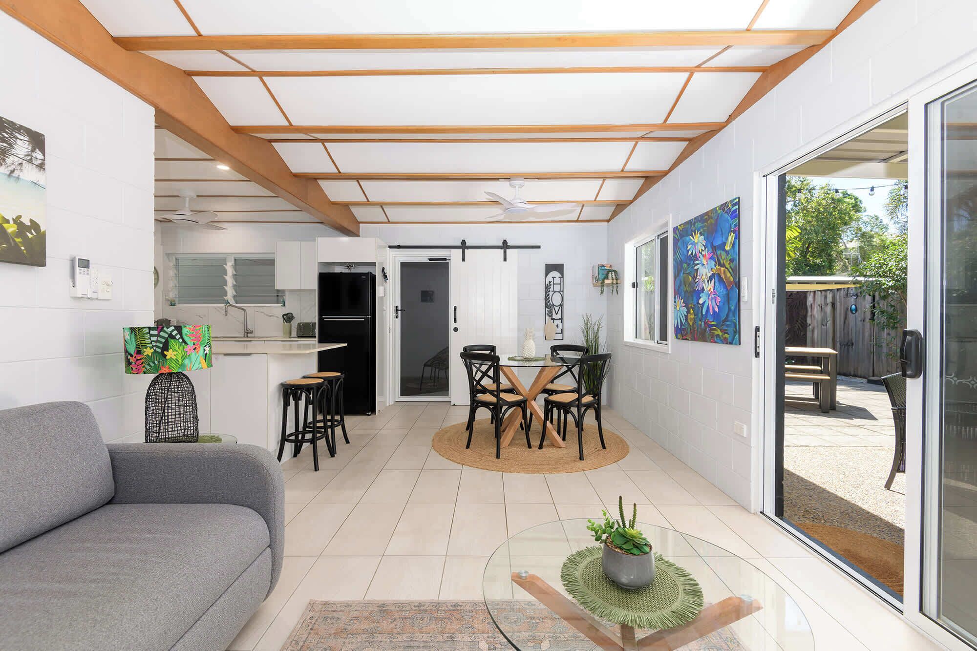 A modern interior with a dining area, kitchen, and living space.
