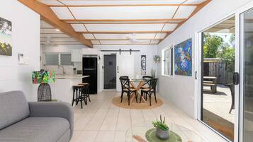 A modern interior with a dining area, kitchen, and living space.