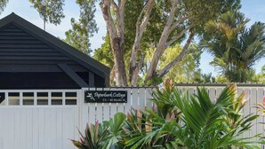 A building with a sign reading 'Paperbark Cottage' at 48 Mudlo St. - Paperbark Cottage - New Tropical Holiday Rental (Port Douglas)
