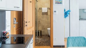 Ein modernes Badezimmer mit einer Glasdusche, einer Toilette und einem Handtuch an einem Halter.