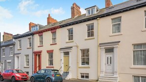 A row of terraced houses with a car parked in front. - 4 Bed in Whitby (oc-w919) (Whitby)