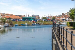 A waterfront view with boats docked, a bridge, and buildings in the background. - 1 Bed in Whitby (oc-w815) (Whitby)