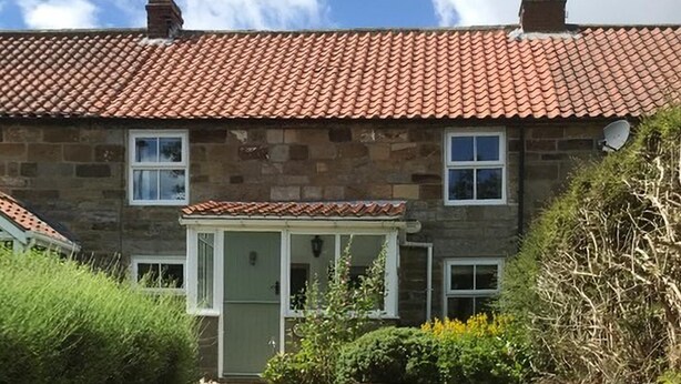 A stone house with a tiled roof, a front porch, and a satellite dish. - 2 Bed in Sleights (oc-wa228a) (Sleights)