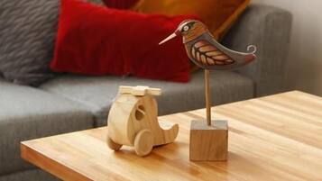 A wooden table with a wooden bird sculpture and a wooden horse sculpture.