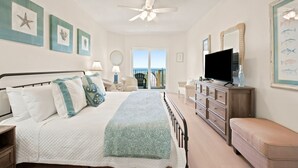 A bedroom with a bed, dresser, TV, and artwork on the walls. - Welcome to Rivieria Dunes #102 (Perdido Key)