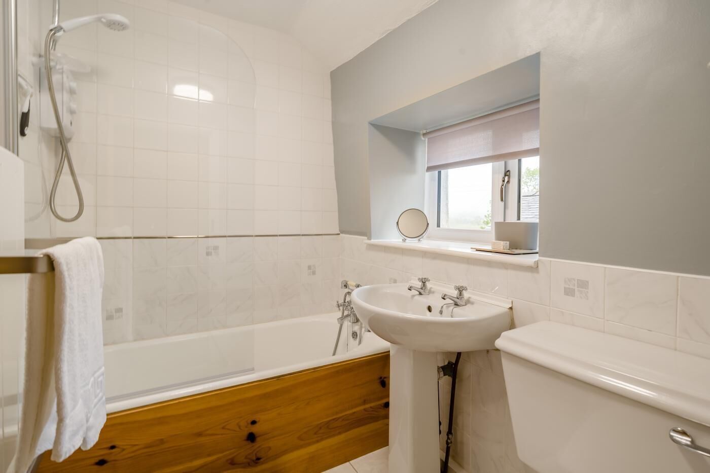 A bathroom with a bathtub, a sink, and a shower.