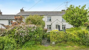 A two-story house with a garden, a gate, and a number '2' sign. - 2 Bed in Ings (oc-s34594) (Ings)